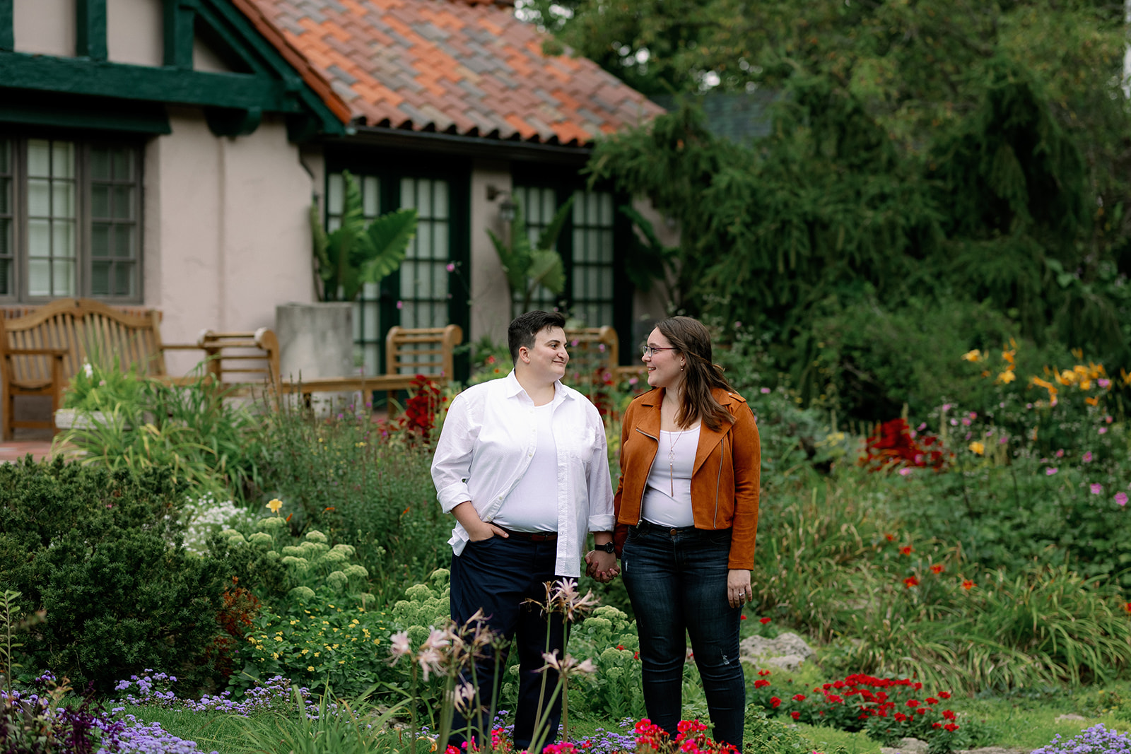 Two women standing in a garden.