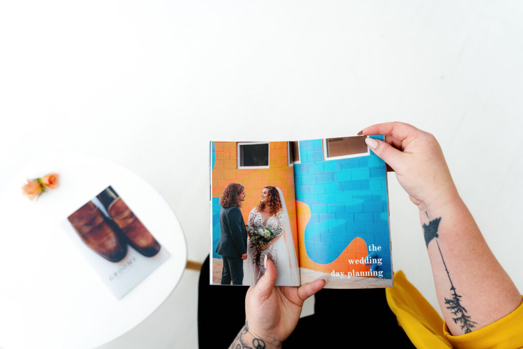 Person holding a custom wedding guide book helpful for connecting with your partner before wedding day