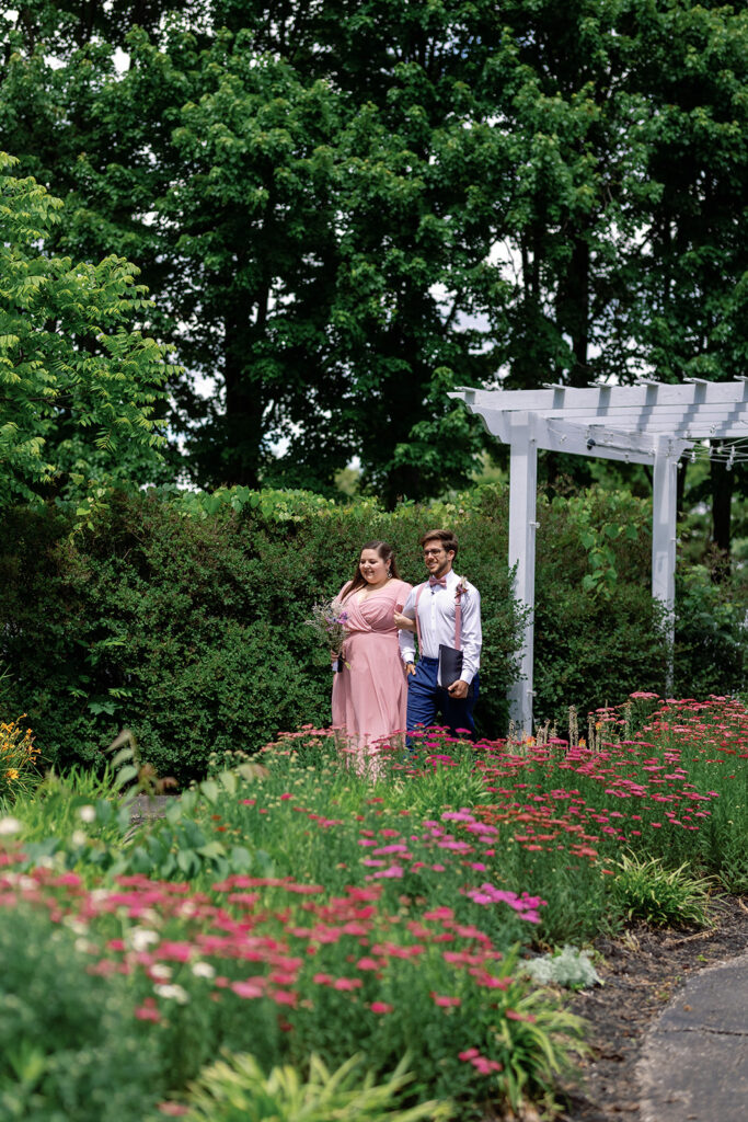 Officiant walking through colorful garden