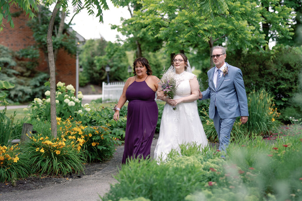 Bride walking to loved ones at alter at The Estate at Sunset Farms