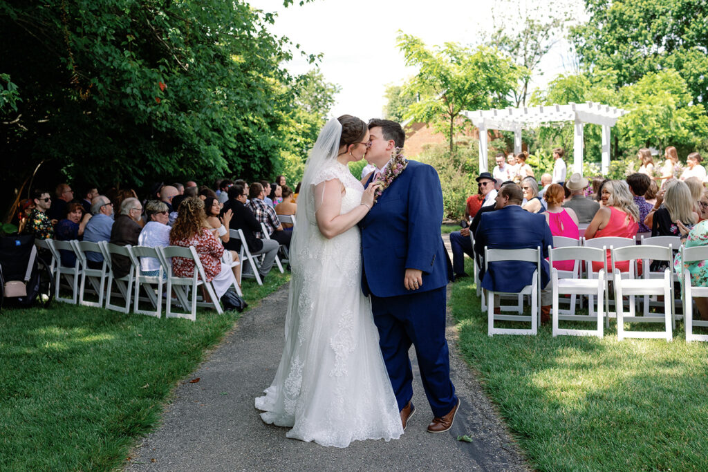 Couple surrounded by loved ones at alter at The Estate at Sunset Farms