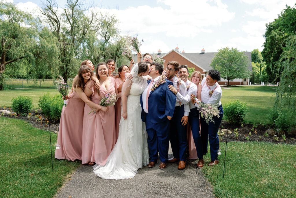 Couple surrounded by wedding party at The Estate at Sunset Farms