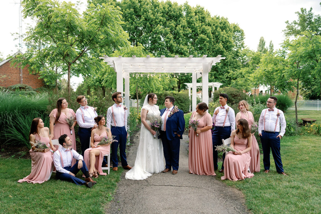 Couple surrounded by wedding party at The Estate at Sunset Farms