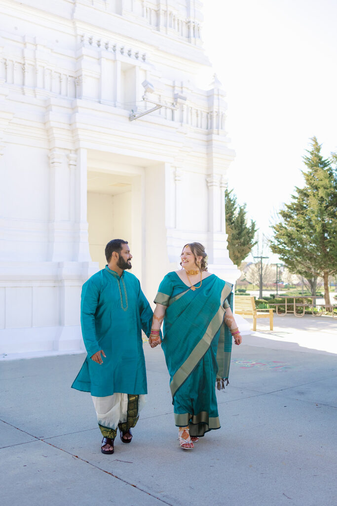 Bride and groom walking for portraits at an Indian Wedding.