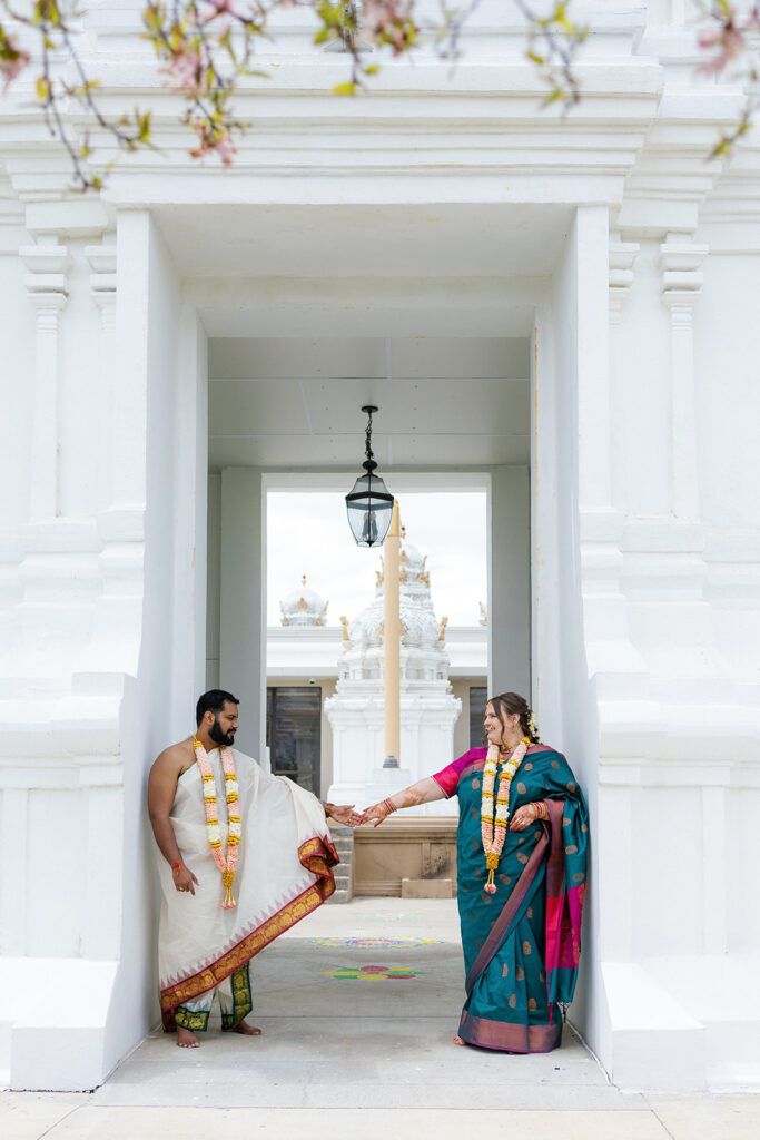 Bride and groom standing for portraits at an Indian Wedding.