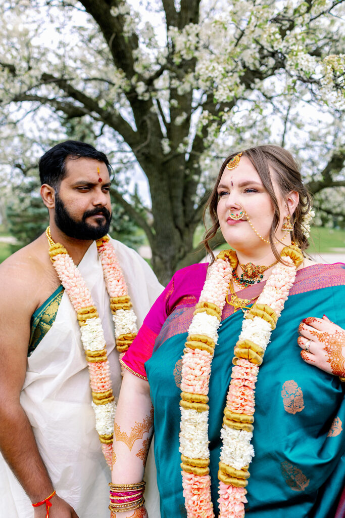 Bride and groom standing for portraits at an Indian Wedding.