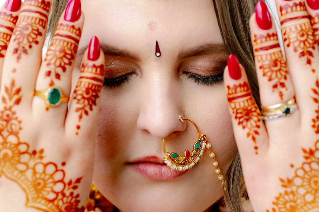 Close-up of the bride's hands adorned with intricate mehendi, at an Indian wedding.