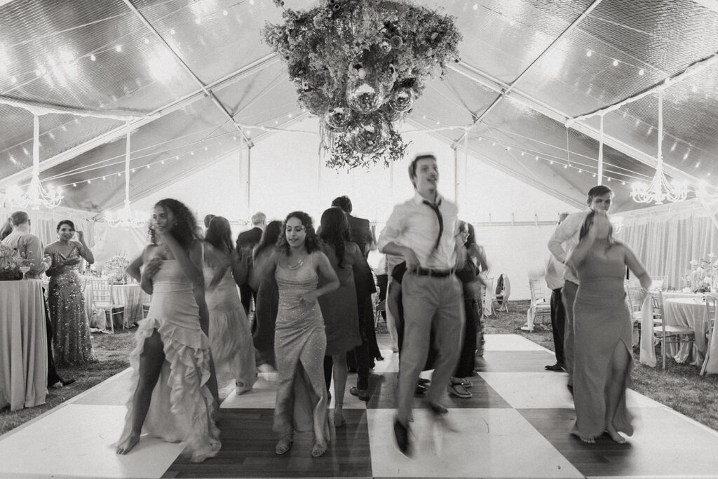 Couple dancing on the dance floor surrounded by guest.