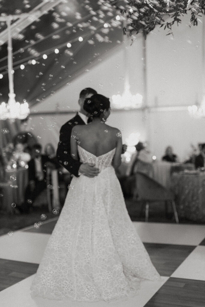 Couple dancing on the dance floor surrounded by guest.