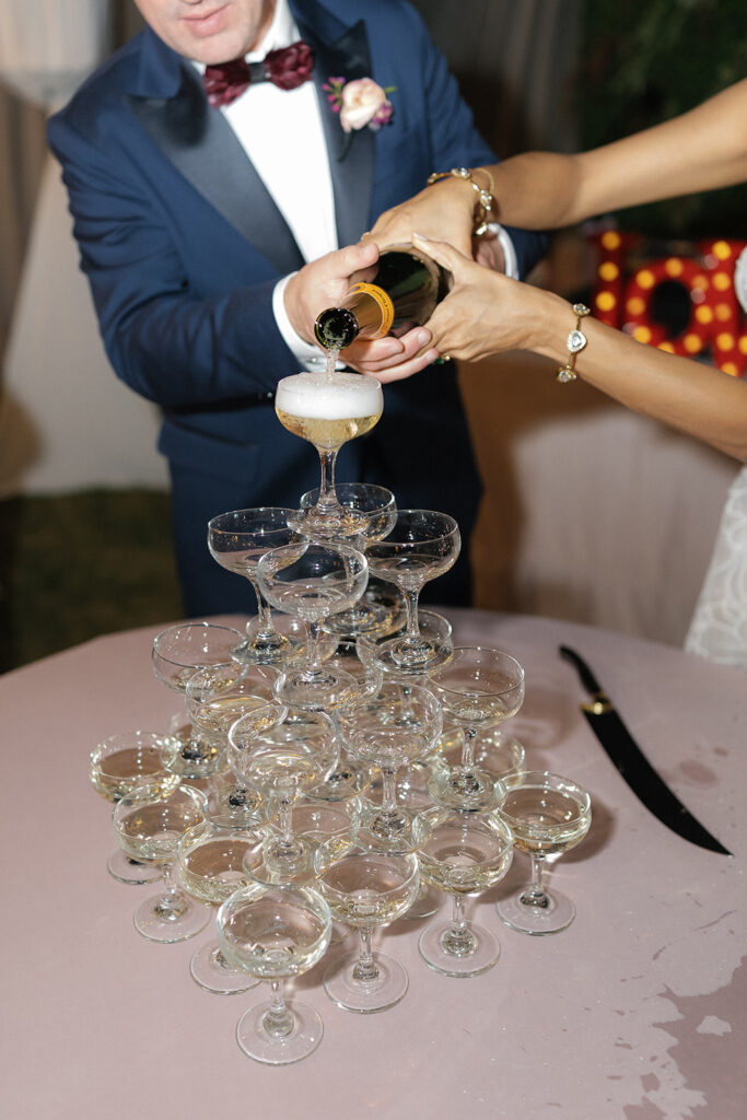 Champagne tower pour by couple at their wedding.