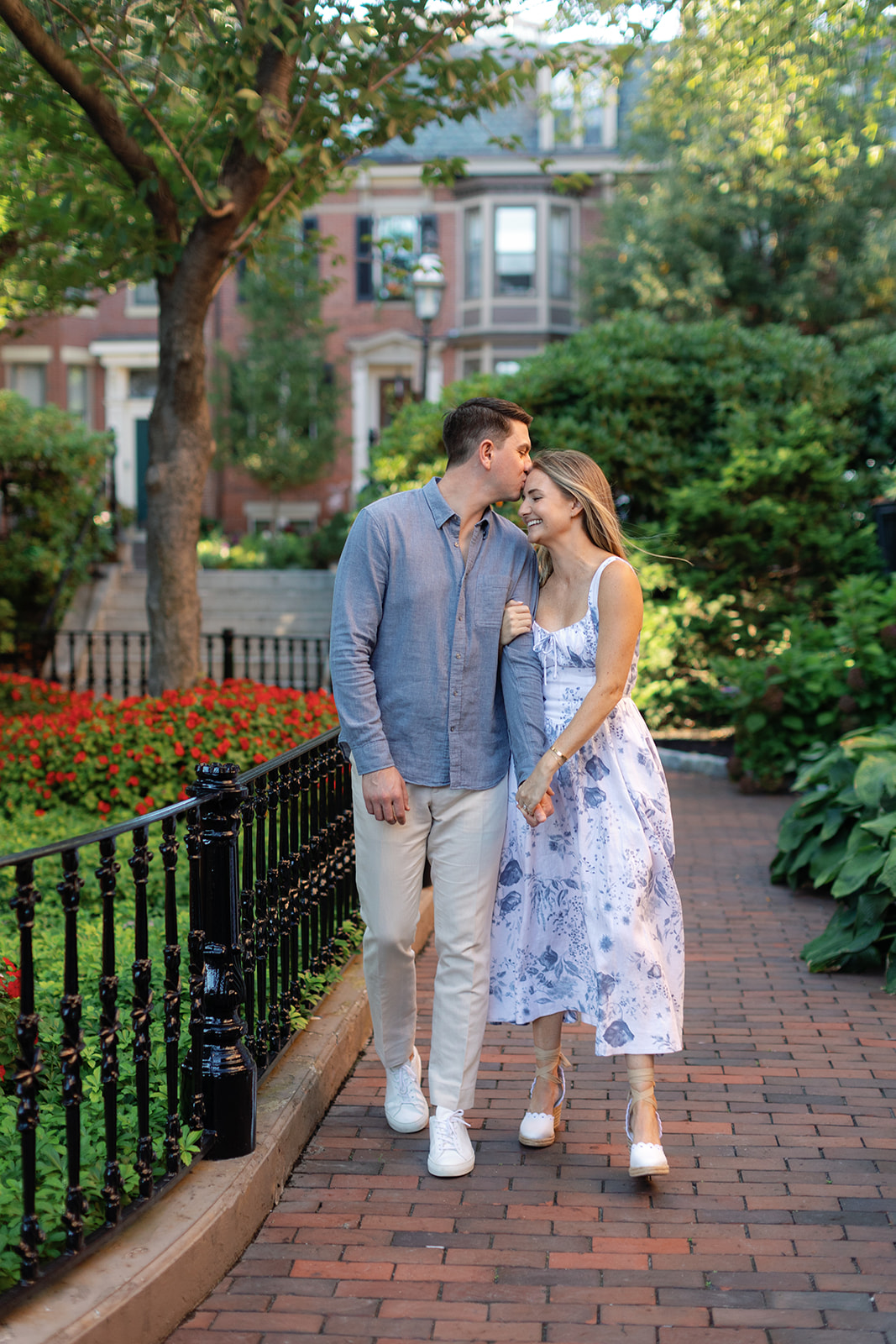 bride and groom to be walking in a park for their engagement