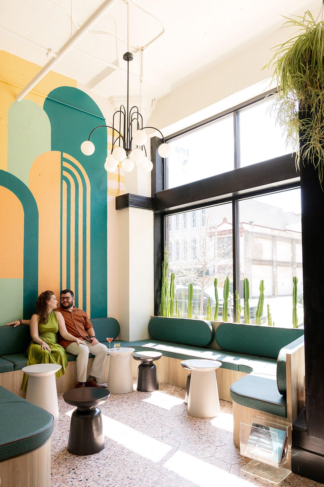 A couple sitting inside a colorful wine bar, Joui Wine in downtown Dayton, Ohio.